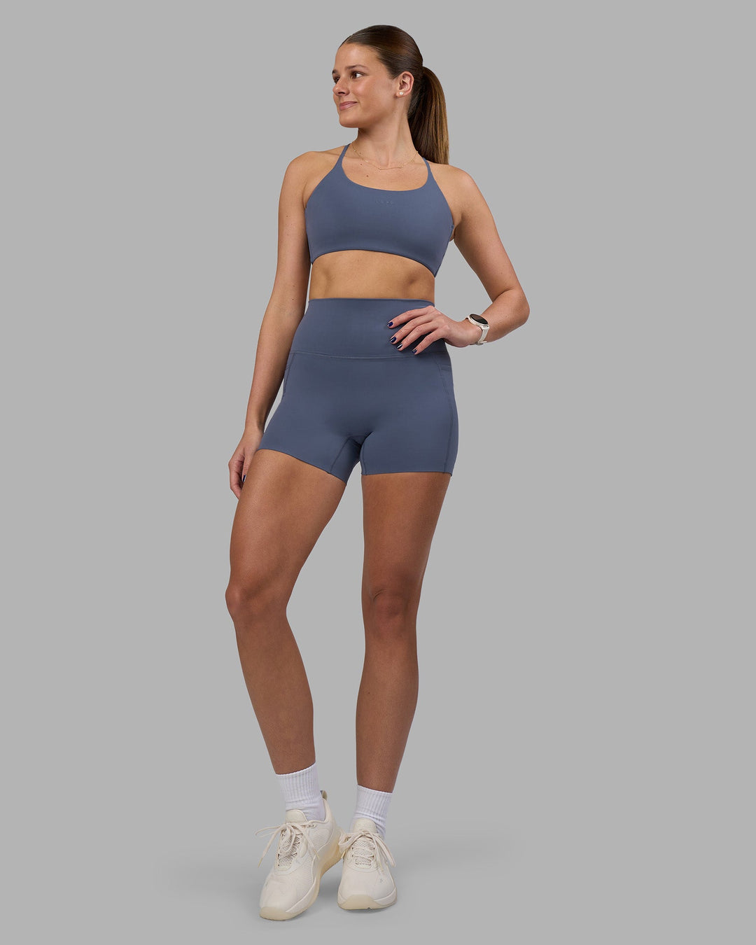 Woman wearing Twist Sports Bra - Night Shadow | Model:Phoebe | Size:S