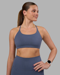 Woman wearing Twist Sports Bra - Night Shadow | Model:Phoebe | Size:S