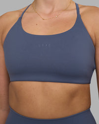 Woman wearing Twist Sports Bra - Night Shadow | Model:Phoebe | Size:S