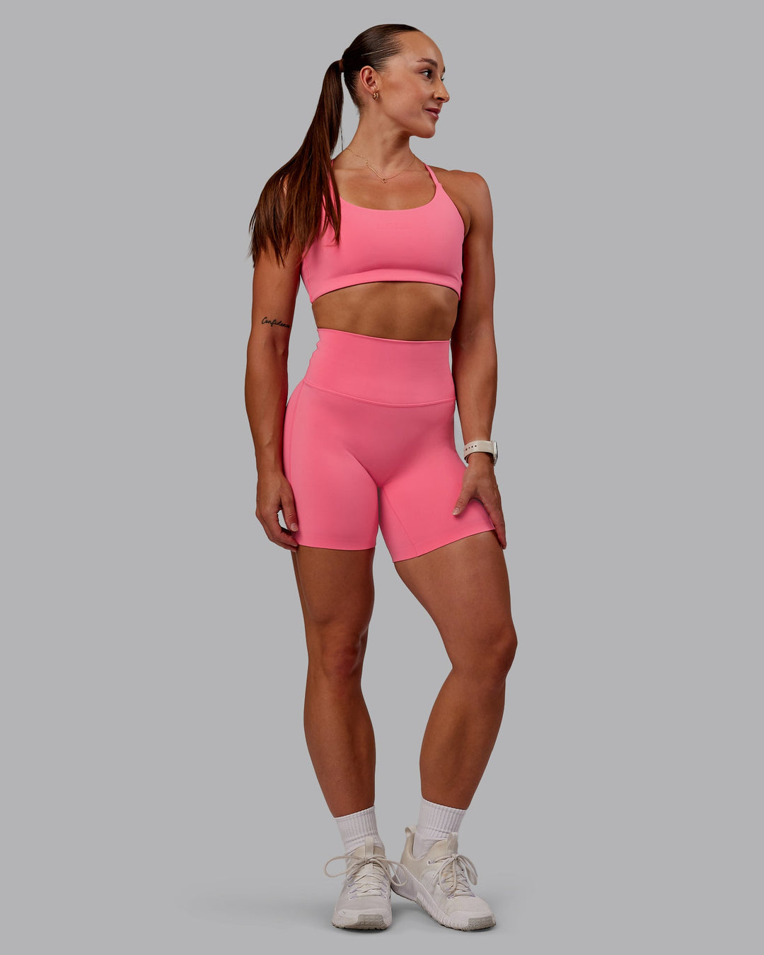 Woman wearing Twist Sports Bra in Pink Lemonade | Size:S