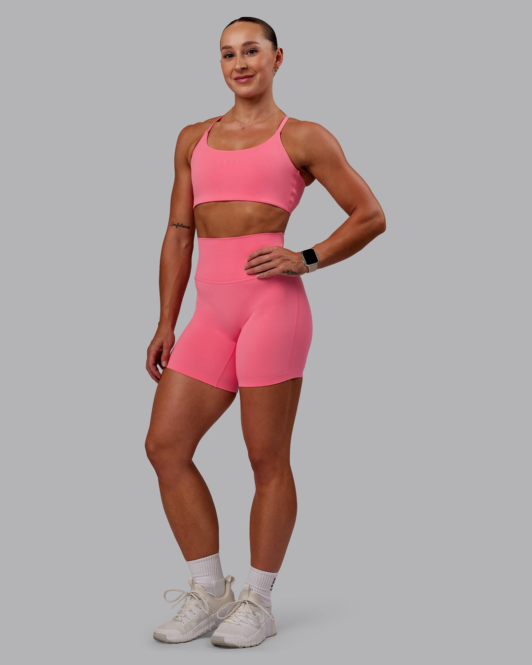 Woman wearing Twist Sports Bra in Pink Lemonade | Size:S