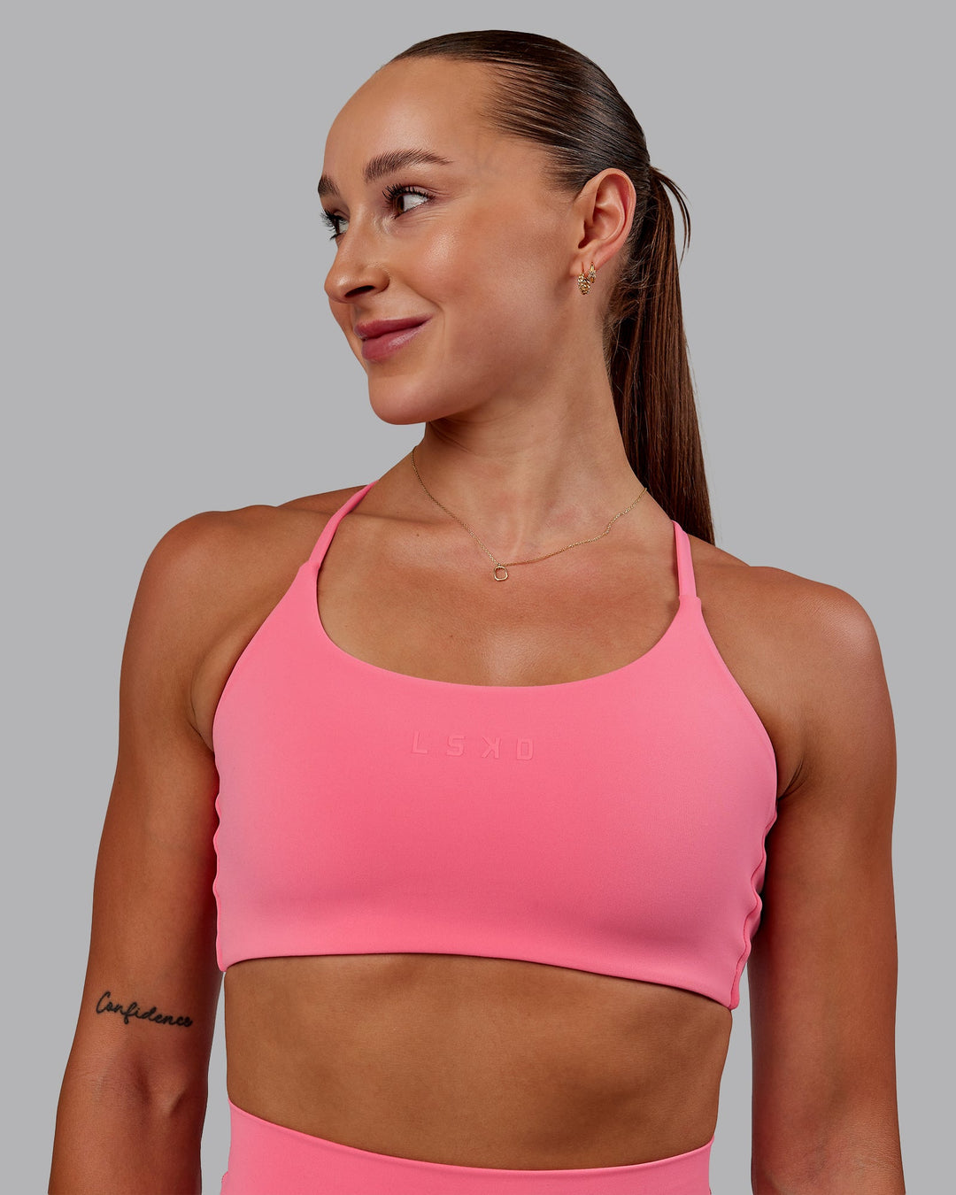 Woman wearing Twist Sports Bra in Pink Lemonade | Size:S