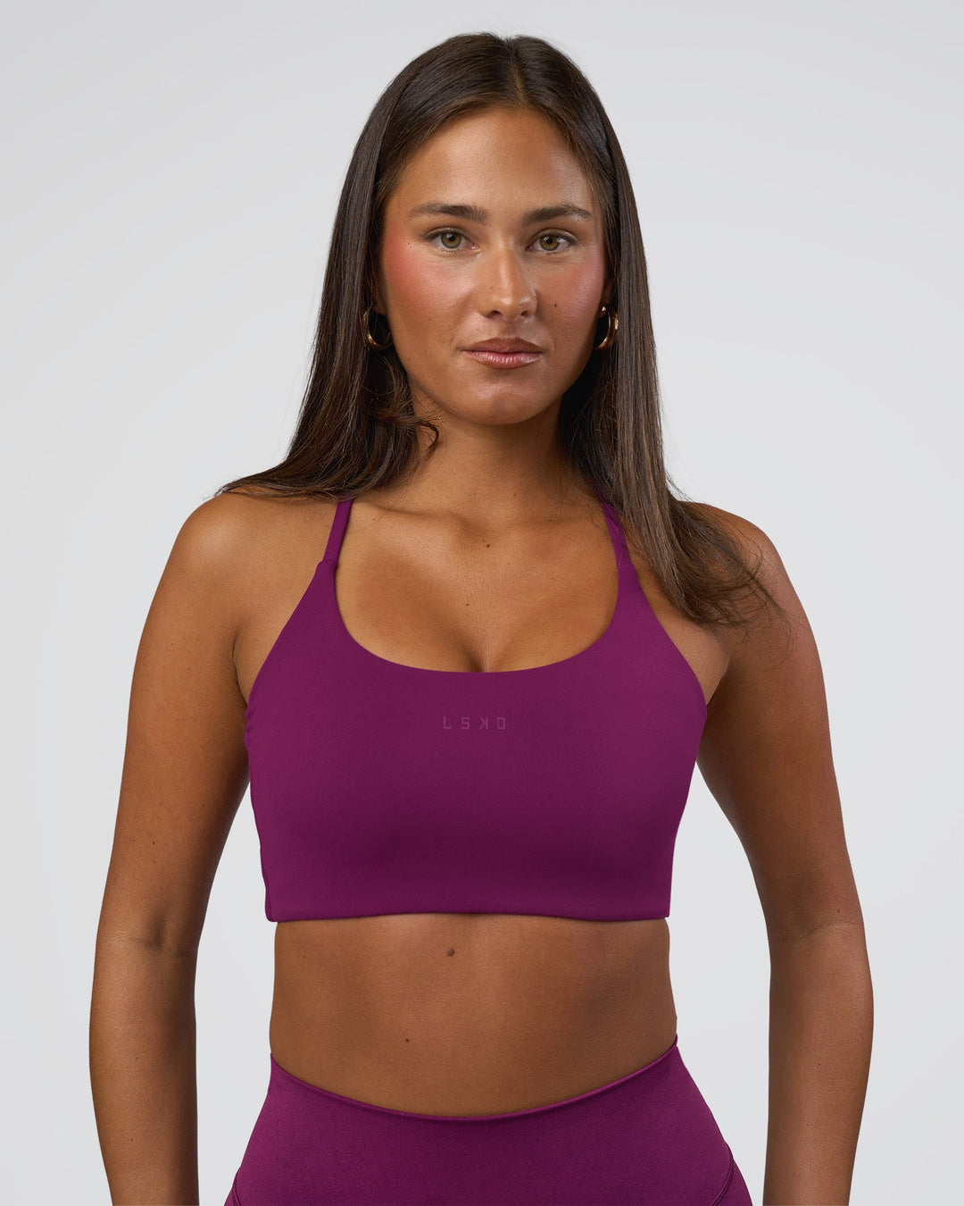 Woman wearing Twist Sports Bra - Plum Caspia | Model:Bianca | Size:S