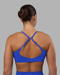 Woman wearing Twist Sports Bra - Power Cobalt | Model:Keisha | Size:S