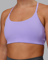 Woman wearing Twist Sports Bra in Violet Ray | Size:S