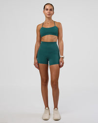 Woman wearing Twister Sports Bra - Transformative Teal | Model:Myrte | Size:S