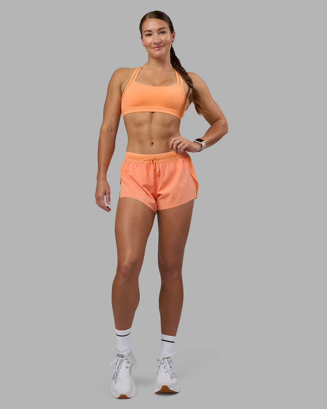 Woman wearing Velocity Sports Bra - Cantaloupe | Model:Hannah | Size:S