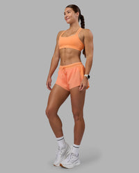Woman wearing Velocity Sports Bra - Cantaloupe | Model:Hannah | Size:S
