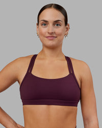 Woman wearing Velocity Sports Bra - Cherry Lacquer | Model:Keisha | Size:S | Thumbnail Index: 0