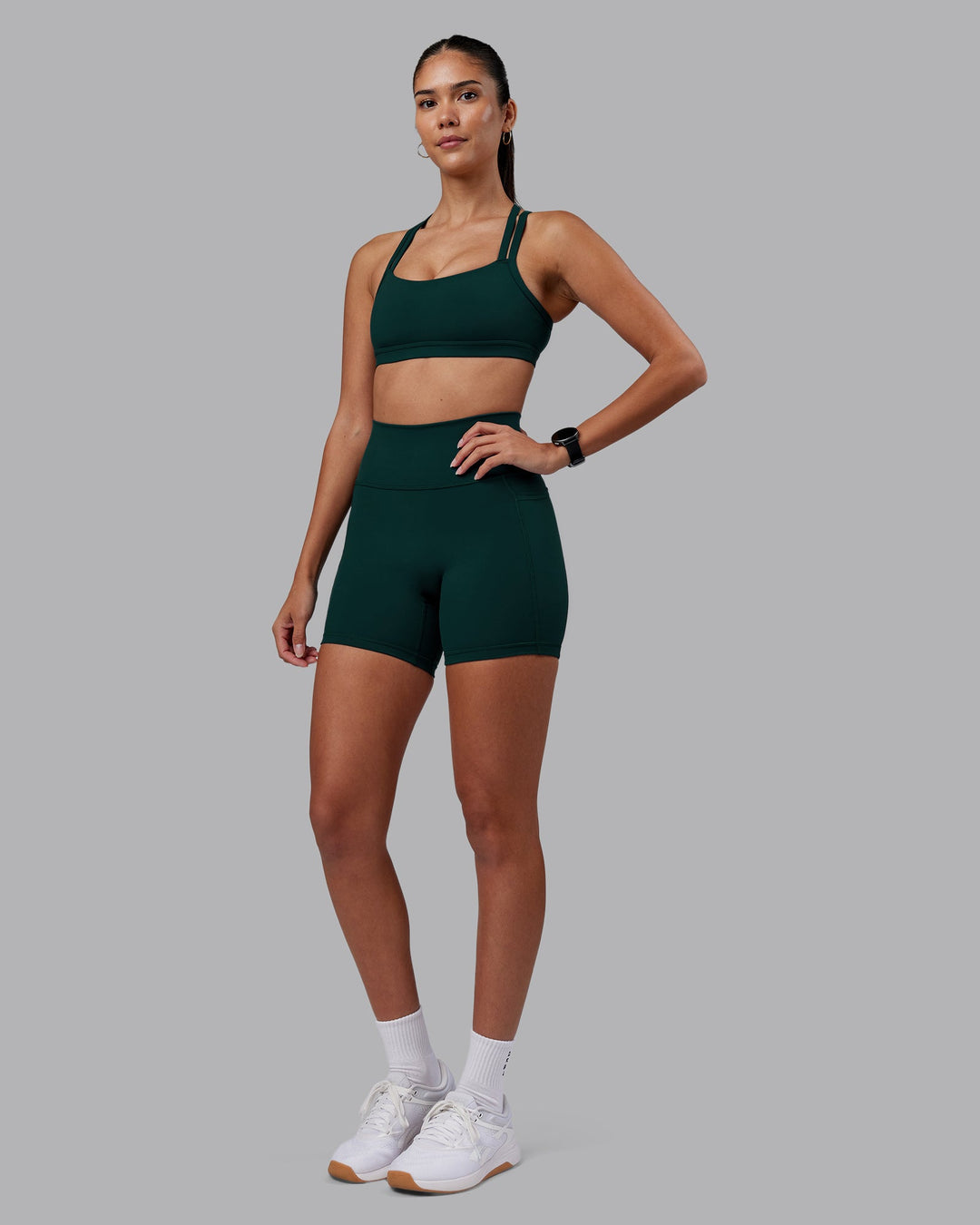 Woman wearing Velocity Sports Bra - Dark Moss | Model:Rhiley | Size:S