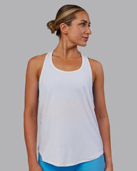 Woman wearing AeroFLX+ Drop Armhole Seamless Tank - White | Model:Paris | Size:S | Thumbnail Index: 4