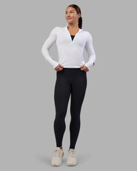 Woman wearing AeroFLX+ Long Sleeve Half Zip - White/White | Model:Hannah | Size:S