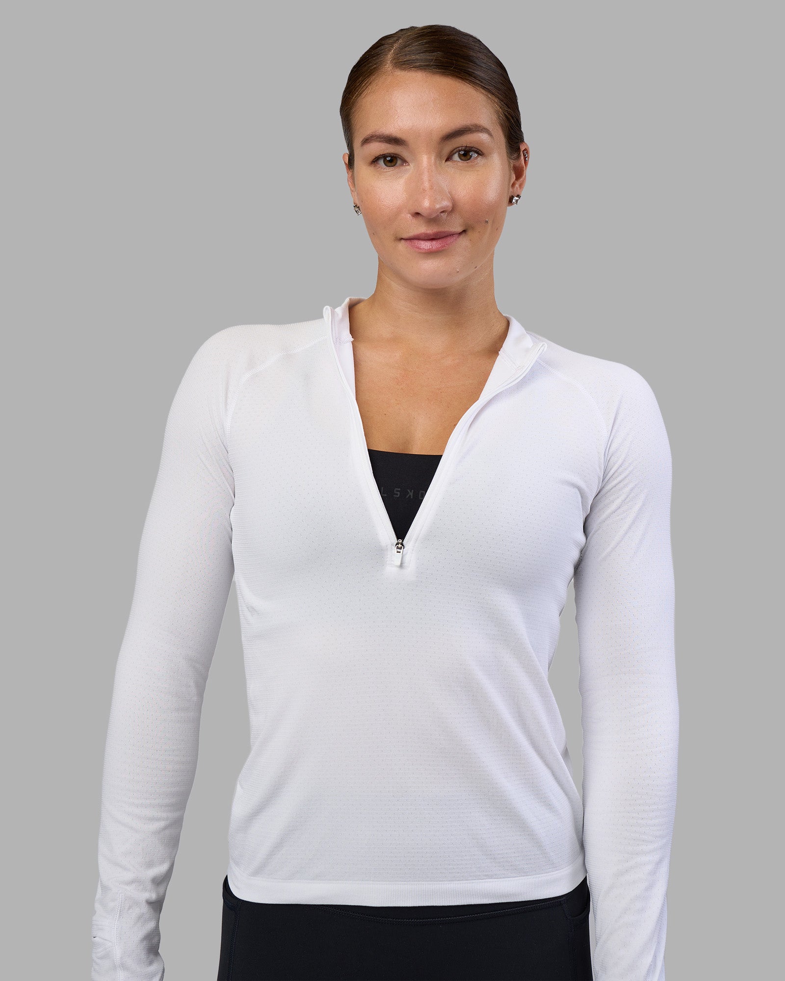 Woman wearing AeroFLX+ Long Sleeve Half Zip - White/White | Model:Hannah | Size:S