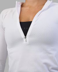 Woman wearing AeroFLX+ Long Sleeve Half Zip - White/White | Model:Hannah | Size:S