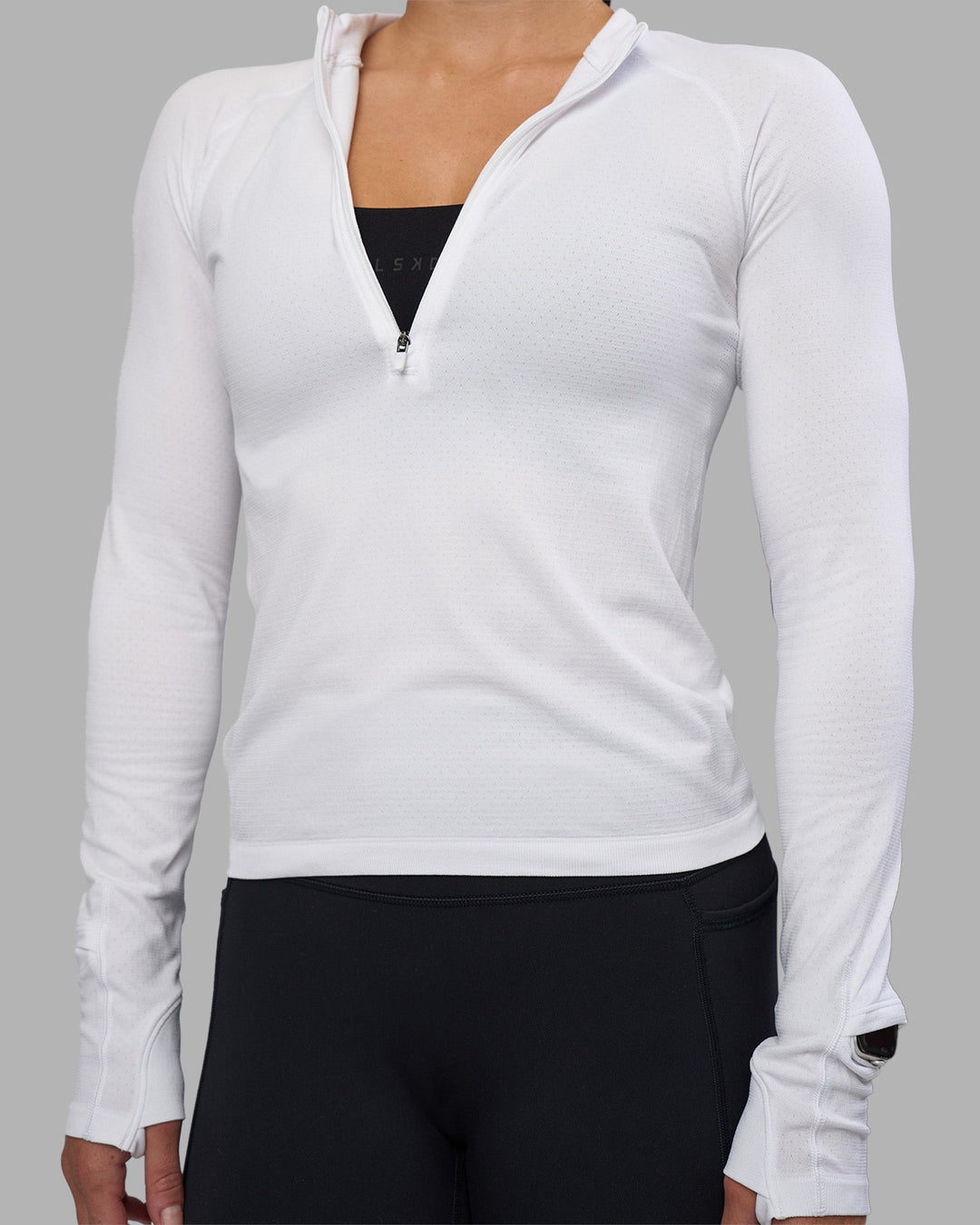 Woman wearing AeroFLX+ Long Sleeve Half Zip - White/White | Model:Hannah | Size:S