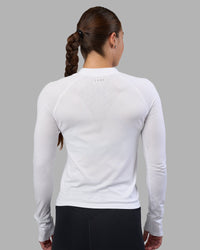 Woman wearing AeroFLX+ Long Sleeve Half Zip - White/White | Model:Hannah | Size:S