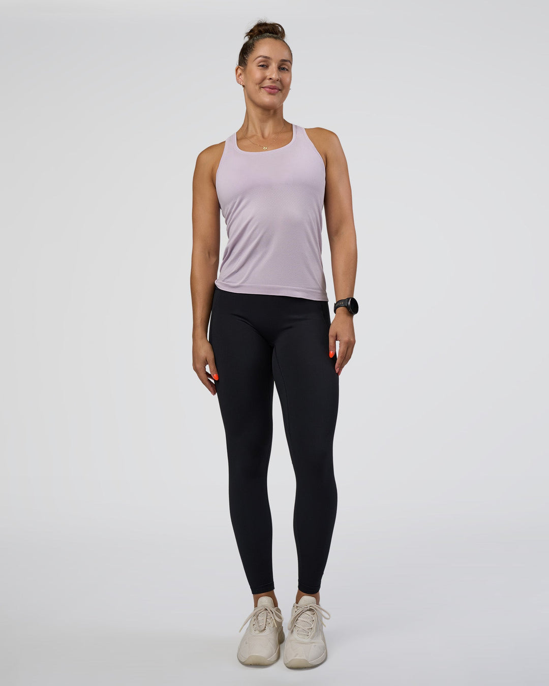 Woman wearing AeroFLX+ Seamless Tank - Fair Orchid/Fair Orchid | Model:Abbey | Size:S