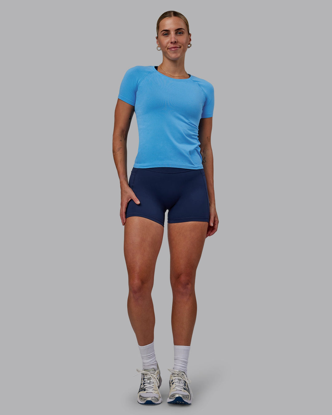 Woman wearing AeroFLX+ Seamless Tee - Azure Blue