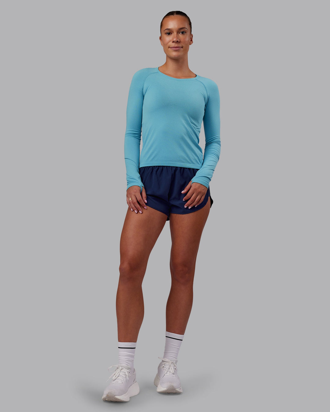 Woman wearing AeroFLX+ Seamless Long Sleeve Tee - Retro Blue/Retro Blue | Model:Charlize | Size:S