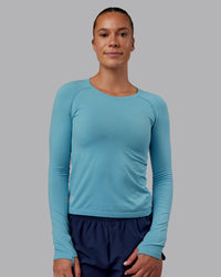 Woman wearing AeroFLX+ Seamless Long Sleeve Tee - Retro Blue/Retro Blue | Model:Charlize | Size:S | Thumbnail Index: 1
