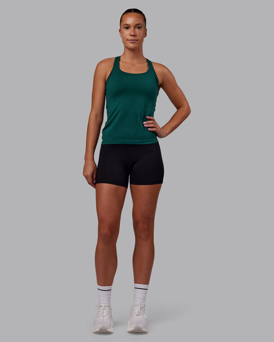 Woman wearing AeroFLX+ Seamless Tank - Dark Moss/Dark Moss | Model:Charlize | Size:S