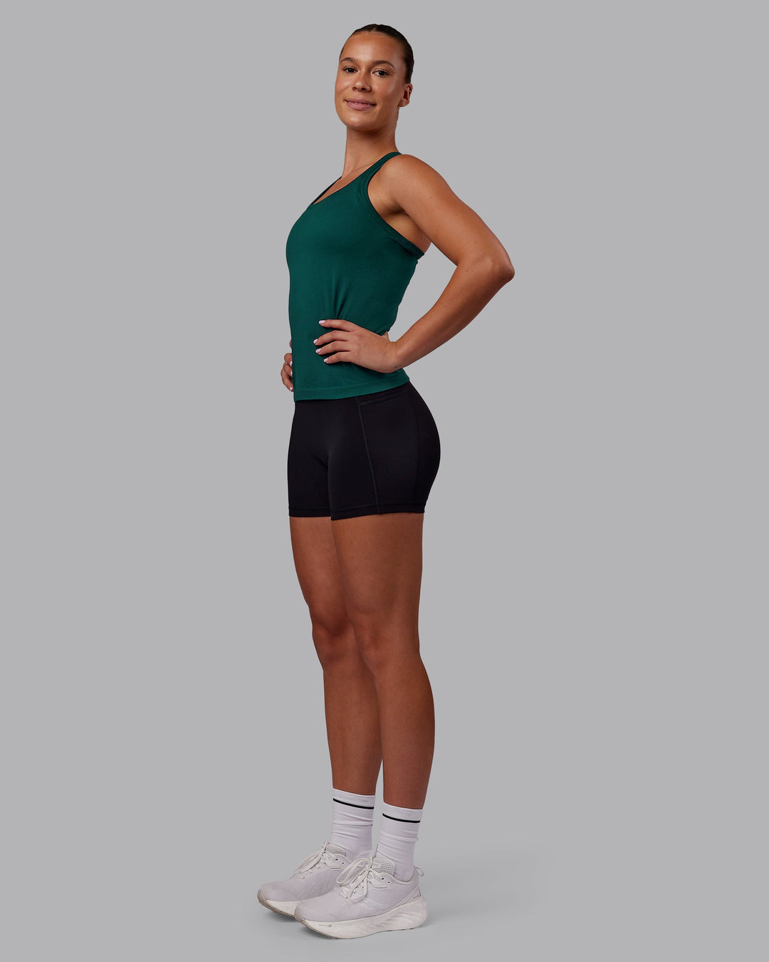 Woman wearing AeroFLX+ Seamless Tank - Dark Moss/Dark Moss | Model:Charlize | Size:S
