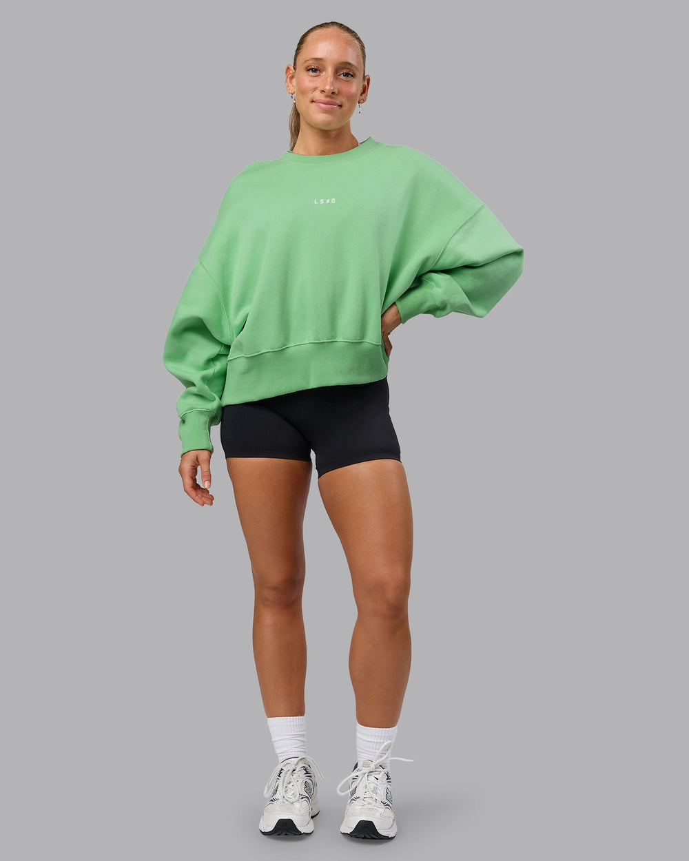 Woman wearing MVP Oversized Sweater - Surreal Green