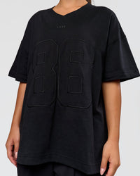 Woman wearing 86 V-Neck Oversized Tee - Black-Black | Model:Sophia | Size:S 