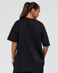 Woman wearing 86 V-Neck Oversized Tee - Black-Black | Model:Sophia | Size:S |