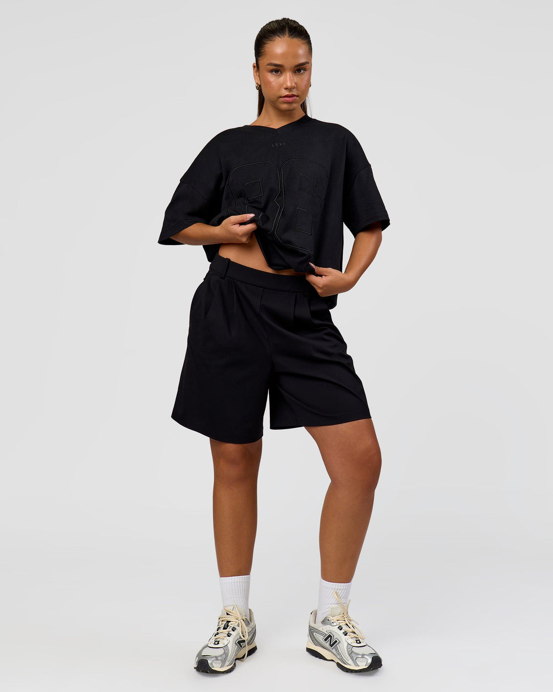 Woman wearing 86 V-Neck Oversized Tee - Black-Black | Model:Sophia | Size:S 