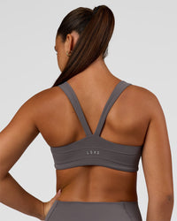 Woman wearing Inertia Sports Bra - Duskstone | Model:Rosie | Size:S | Thumbnail Index: 1