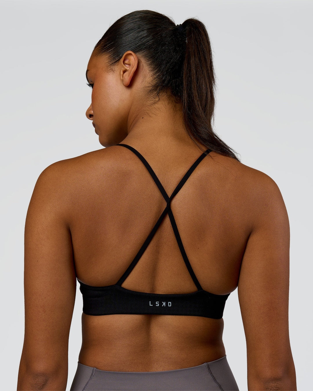 Woman wearing Infinite Contour Sports Bra - Black| Model:Rosie | Size:S - view 2