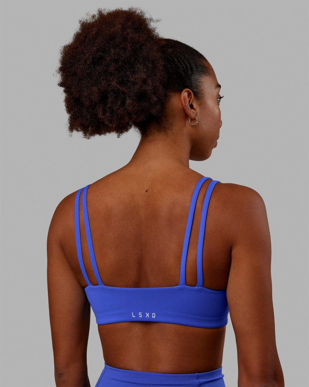 Woman wearing Vogue Sports Bra - Power Cobalt