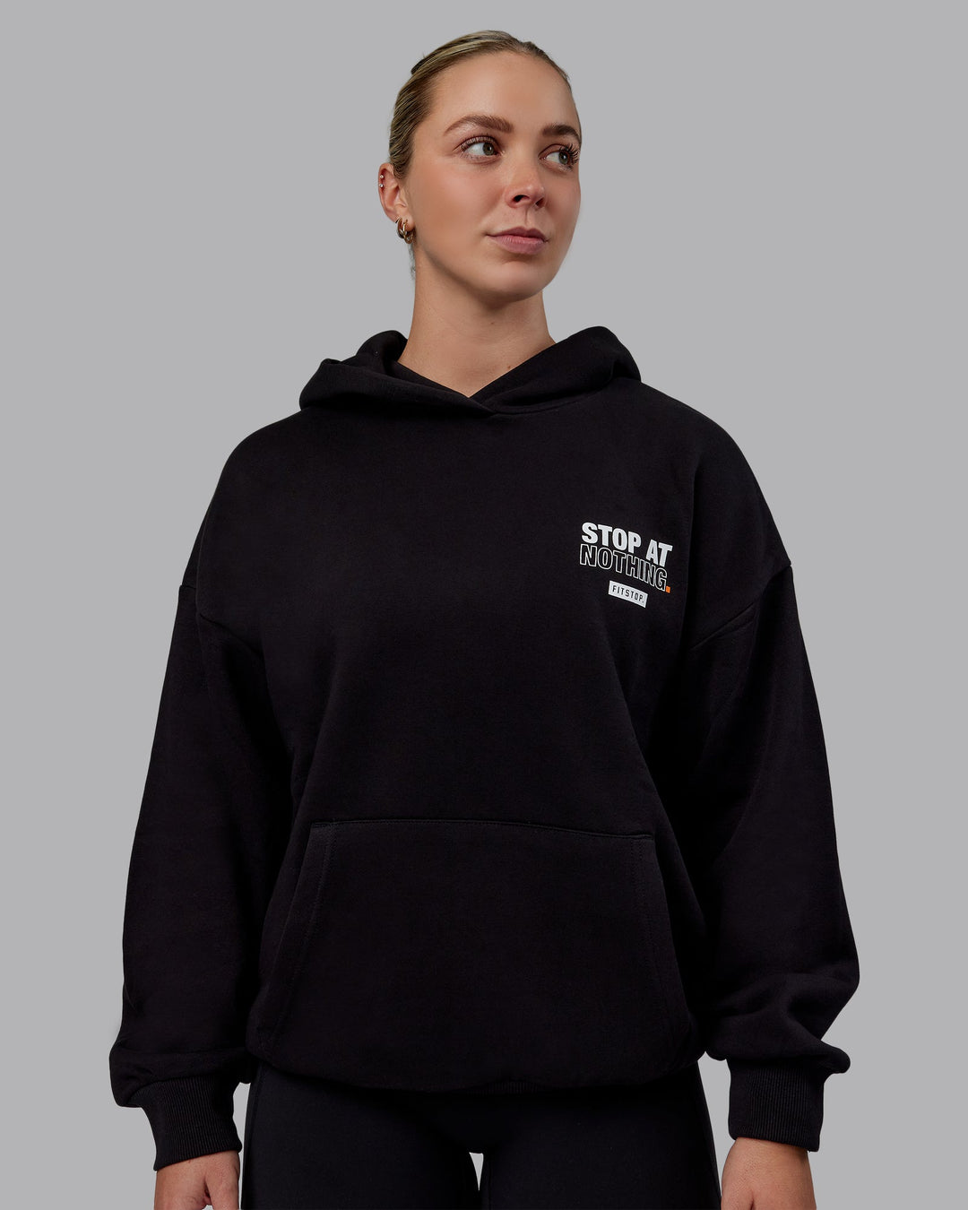 Woman wearing Unisex Fitstop Stop at Nothing Hoodie Oversize - Black