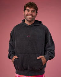 Man wearing BCAM Washed Unisex Oversized Hoodie - Black Washed-Pink | Model:Fletcher | Size:XL