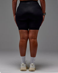 Woman wearing Fusion Ultra High-Rise 9" Short Pockets - Black | Model:Aimee | Size:XL