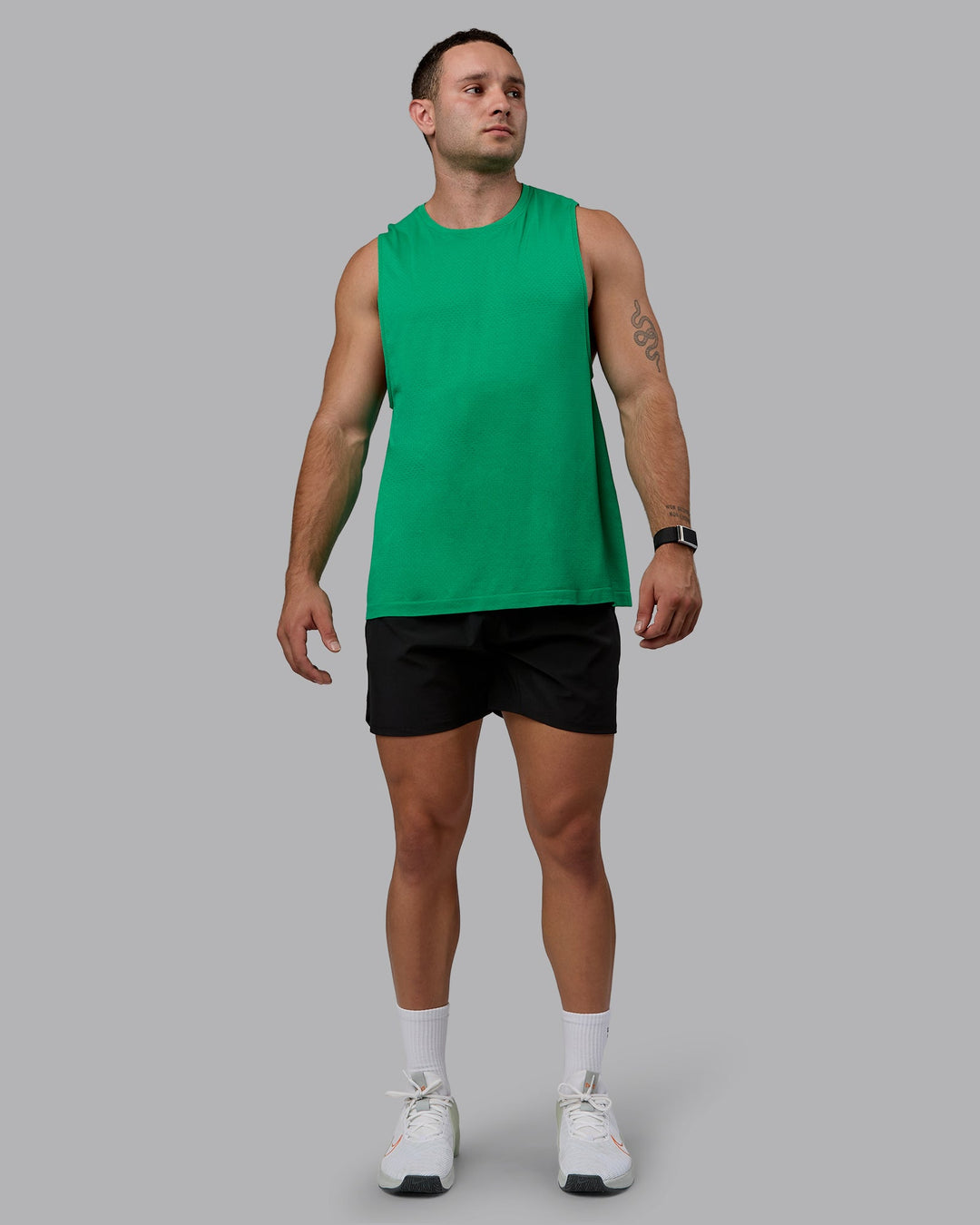 Man wearing AeroFLX+ Seamless Muscle Tank - Pepper Green/Impact Green