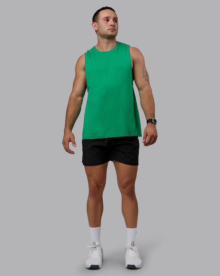 Man wearing AeroFLX+ Seamless Muscle Tank - Pepper Green/Impact Green
