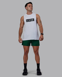 Man wearing Rep 5" Performance Shorts - Deep Emerald