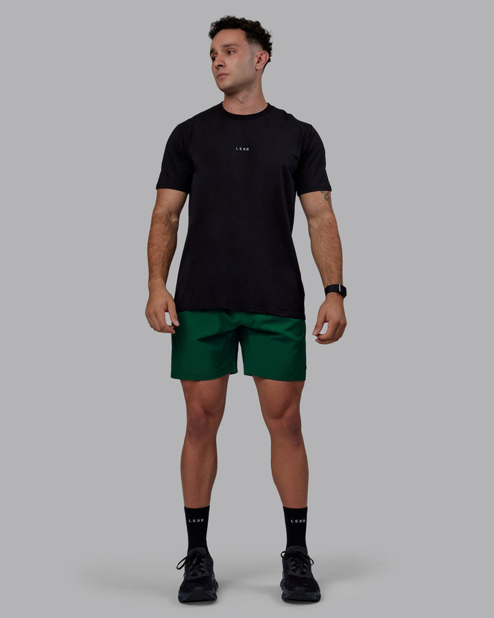 Man wearing Rep 7&quot; Performance Shorts - Deep Emerald
