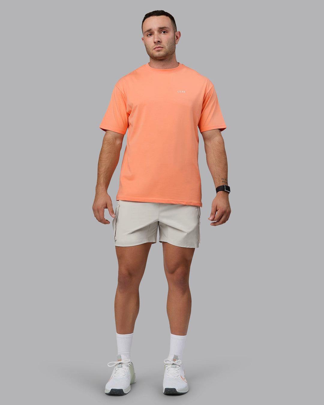 Man wearing Unisex 1% Better Value Series FLXCotton Tee Oversize - Mellow Peach-White