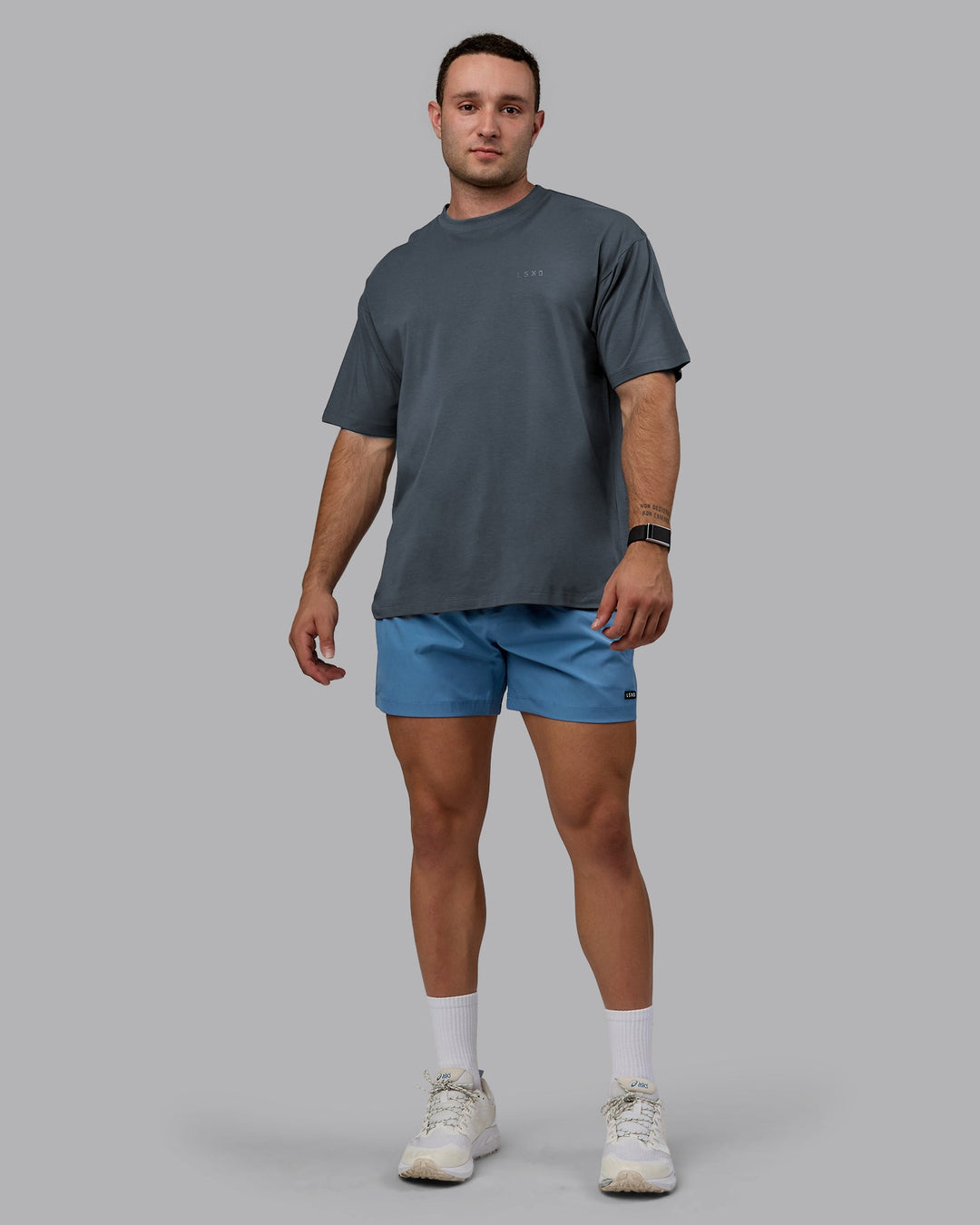 Man wearing Unisex Deluxe PimaFLX Tee Oversize - Turbulence