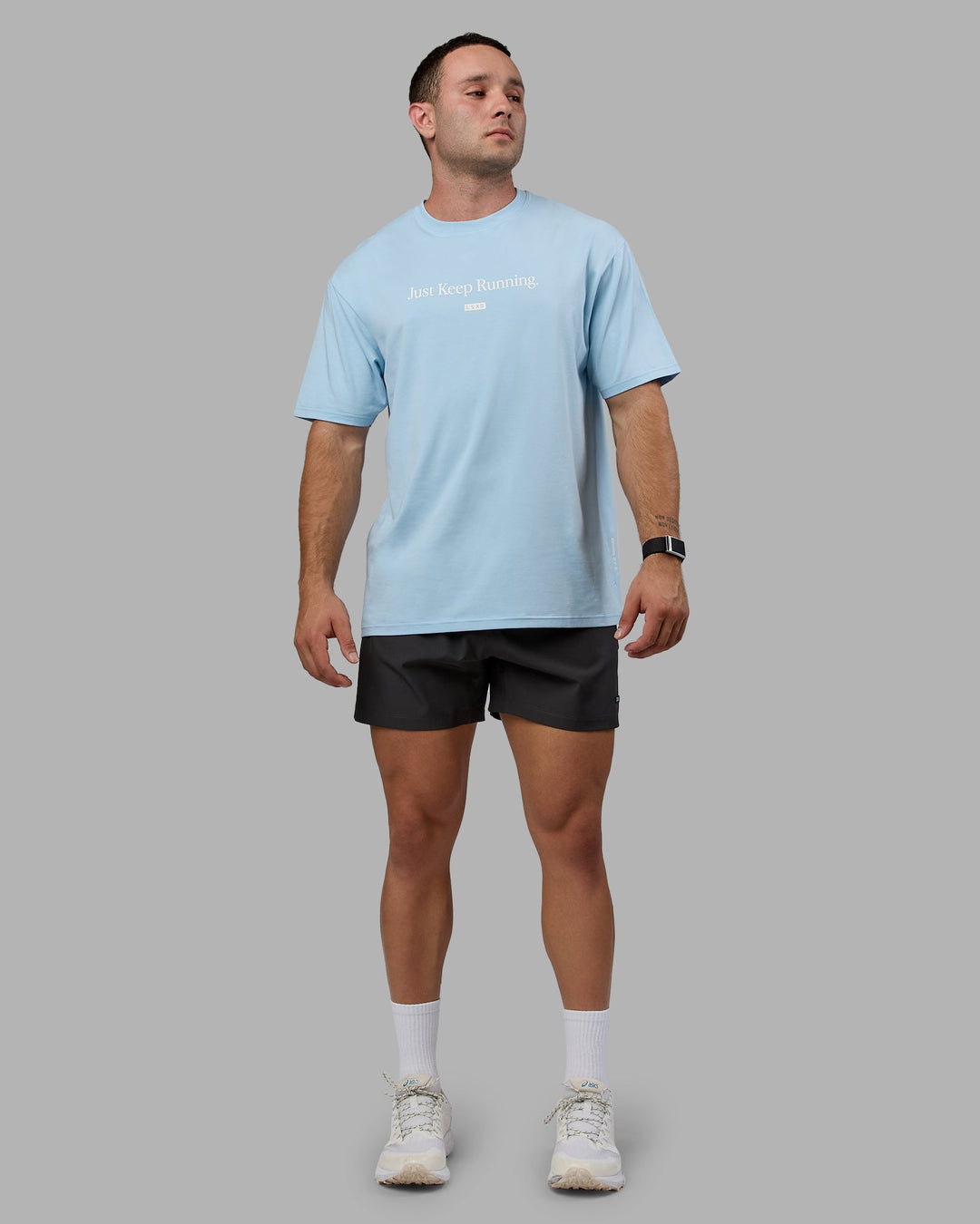 Man wearing Unisex Just Keep Running FLXCotton Tee Oversize - Glacial Blue-Off White