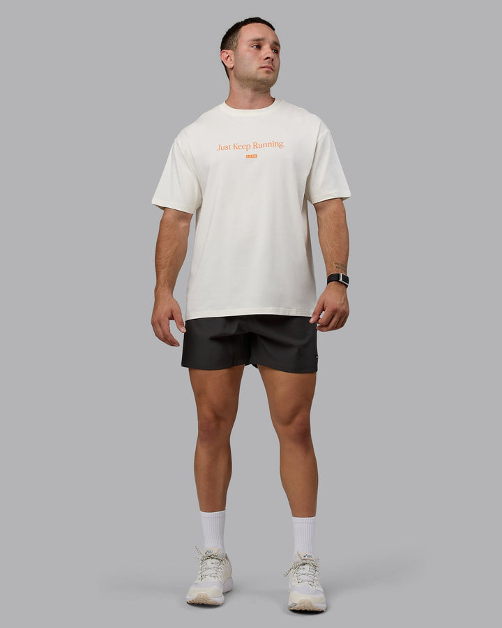 Man wearing Unisex Just Keep Running FLXCotton Tee Oversize - Off White-Vibrant Orange
