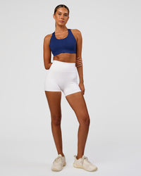 Woman wearing Stability High Support Sports Bra - Midnight Blue | Model:Charli | Size:XS (A-C Cup) | Thumbnail Index: 2