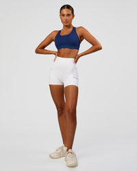 Woman wearing Stability High Support Sports Bra - Midnight Blue | Model:Charli | Size:XS (A-C Cup) | Thumbnail Index: 5