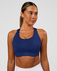 Woman wearing Stability High Support Sports Bra - Midnight Blue | Model:Charli | Size:XS (A-C Cup) | Thumbnail Index: 0