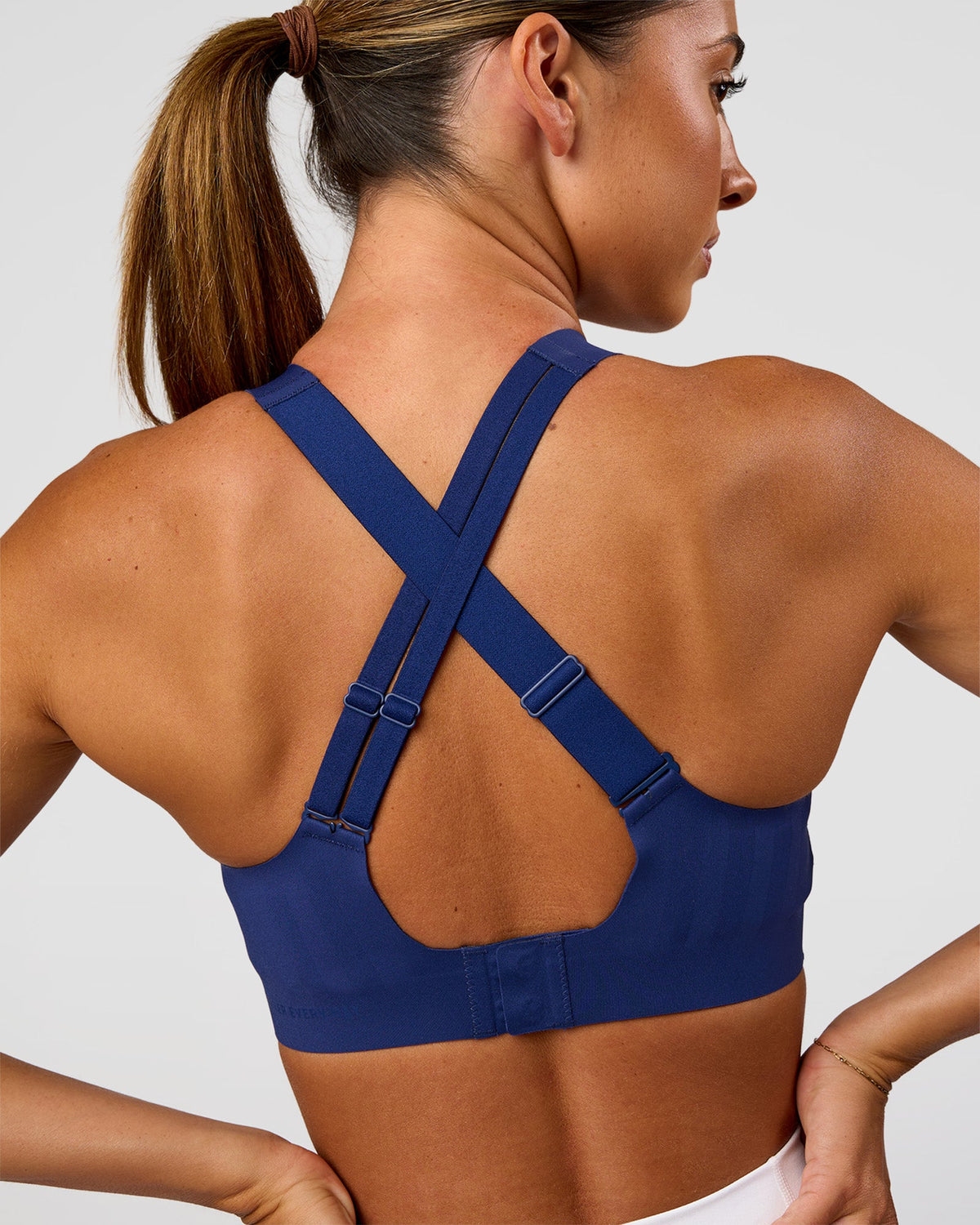 Woman wearing Stability High Support Sports Bra - Midnight Blue | Model:Charli | Size:XS (A-C Cup) - view 2