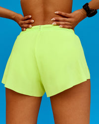 Woman wearing Accelerate 3" Running Short - Lime Glo | Model:Txai | Size:XS