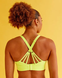 Woman wearing Accelerate Split Strap Sports Bra - Hyper Green | Model:Txai | Size:XS